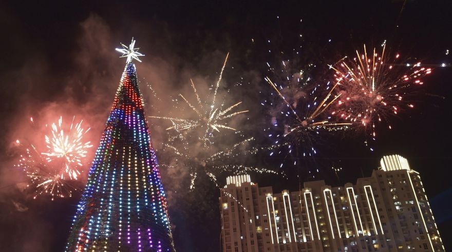 Fireworks explode next to a 38 metre Christmas tree on Christmas day at a shopping center in Jakarta on December 25, 2015. AFP PHOTO / ADEK BERRY